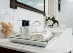 Beautiful amenity hotel set on white marble counter in bathroomm